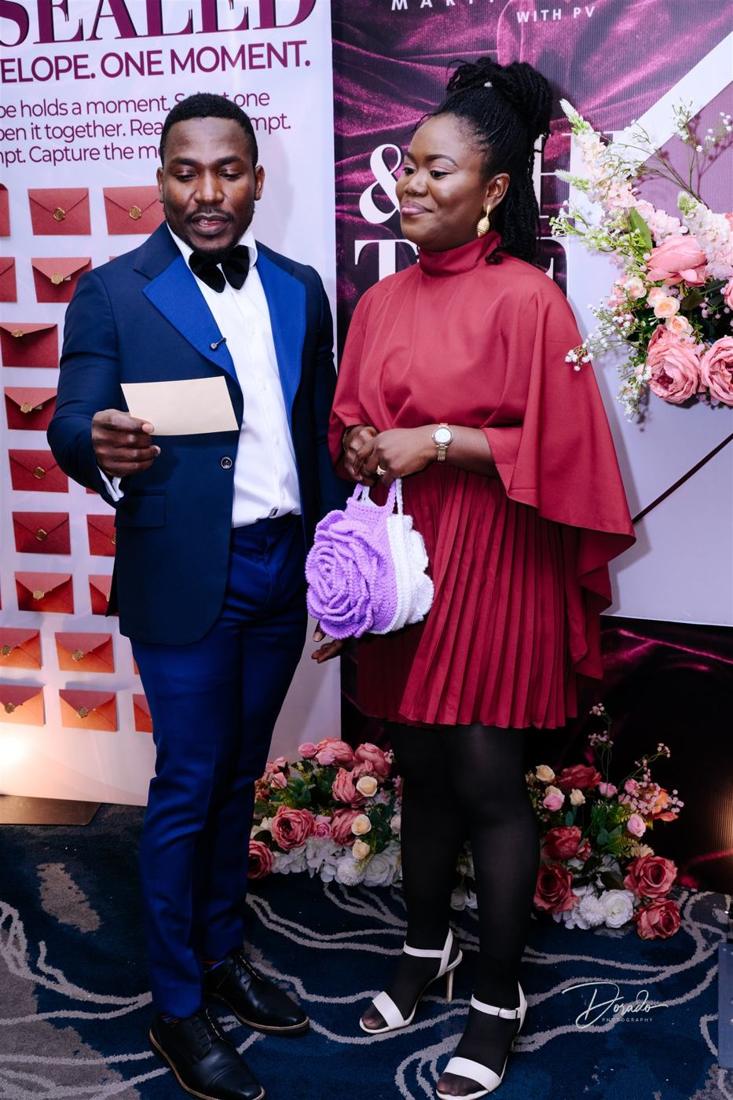 A couple at the photo backdrop