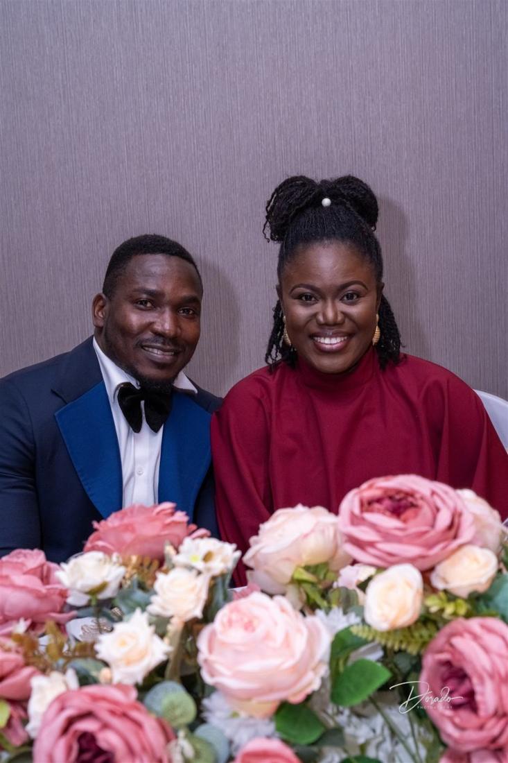 A couple behind the floral centrepiece